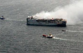 towing-begins-of-cargo-ship-ablaze-off-dutch-coast